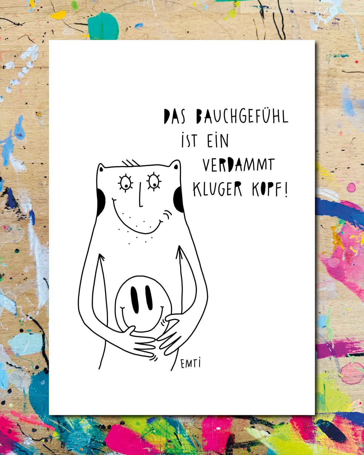 Postkarte: eine Figur hält einen lachenden Smiley vor den Bauch, dazu der Schriftzug „Das Bauchgefühl ist ein verdammt kluger Kopf!“